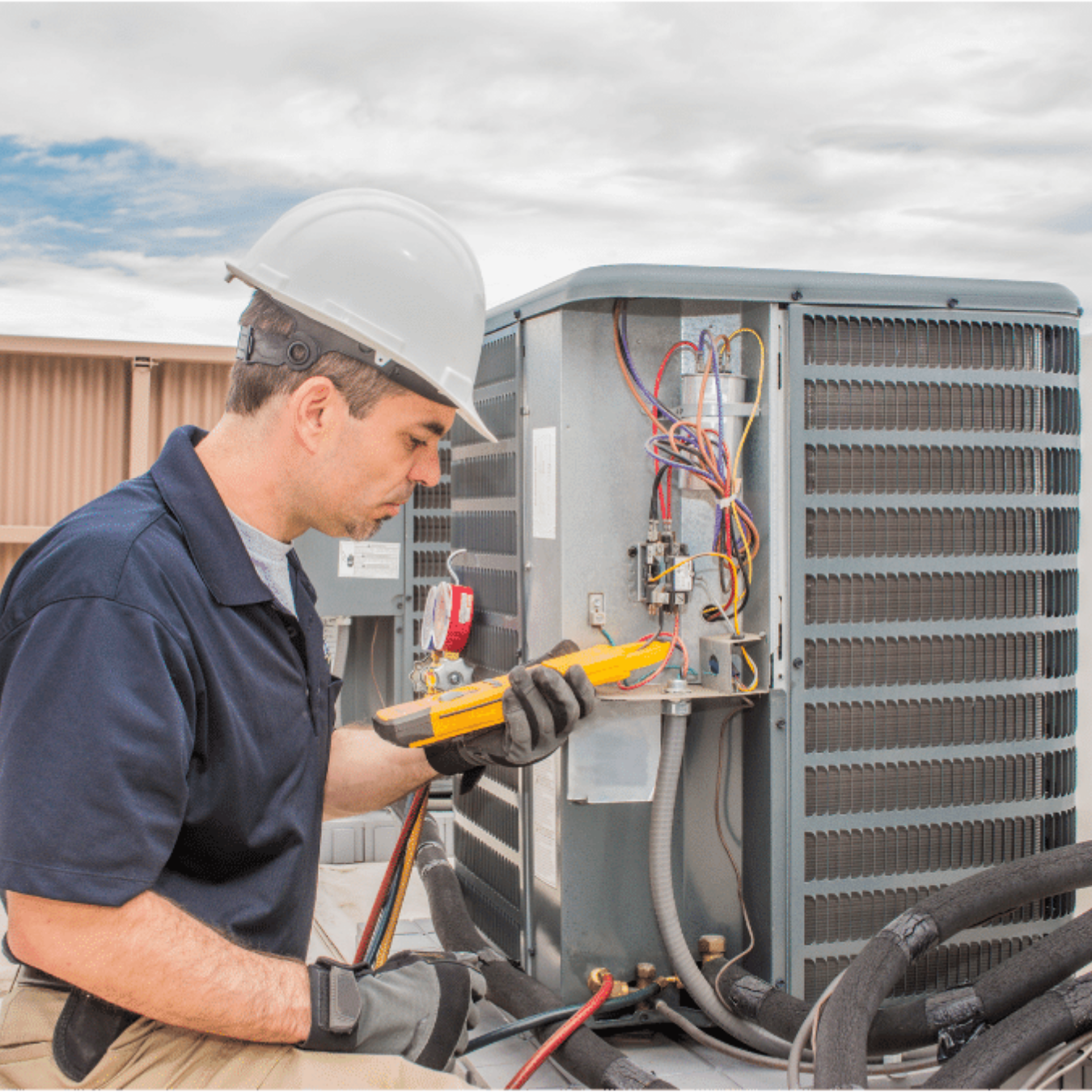Aurora Heating & Cooling HVAC technician servicing a system
