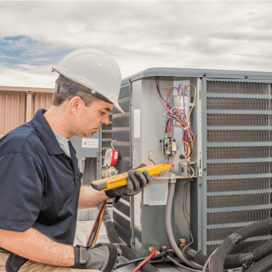 Aurora Heating & Cooling HVAC technician servicing a system